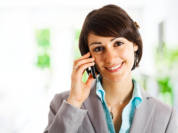 woman smiling while talking the phone